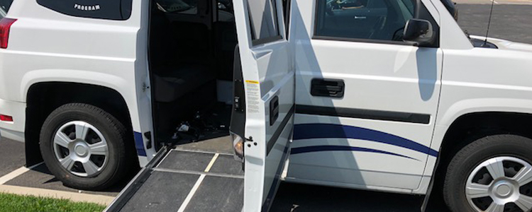 Photo of accessible white van with entry door open